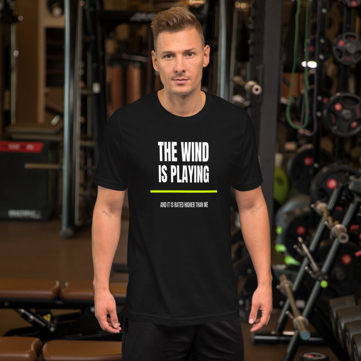 The Wind Is Playing Too black unisex t-shirt worn by a model -- tennis court style